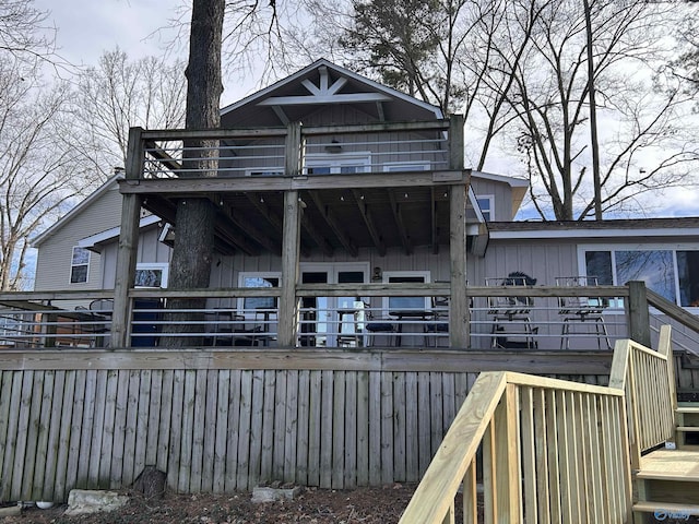 back of property featuring board and batten siding and a wooden deck