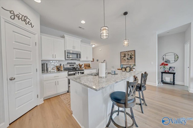16604 Demi Dr, Athens, AL 35613 - kitchen featuring stainless steel appliances, light wood-type flooring, a sink, and white cabinetry