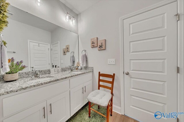 16604 Demi Dr, Athens, AL 35613 - bathroom featuring double vanity, a sink, and wood finished floors