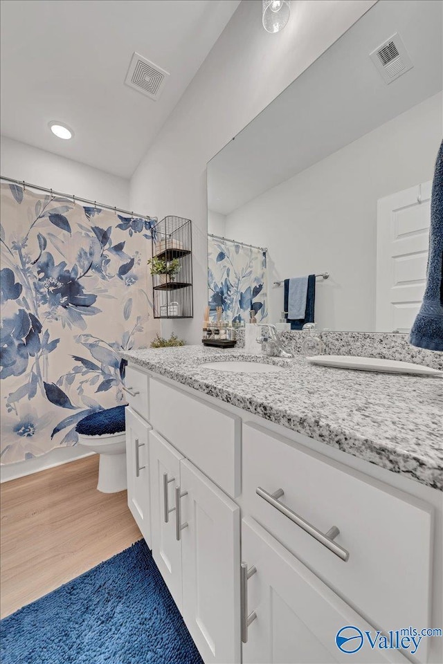 16604 Demi Dr, Athens, AL 35613 - full bathroom with toilet, visible vents, wood finished floors, and vanity