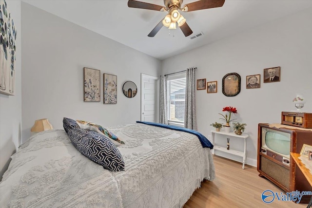 16604 Demi Dr, Athens, AL 35613 - bedroom with baseboards, light wood finished floors, visible vents, and a ceiling fan