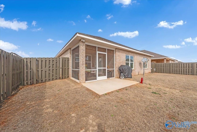 16604 Demi Dr, Athens, AL 35613 - rear view of house featuring a patio area, a fenced backyard, a sunroom, and brick siding