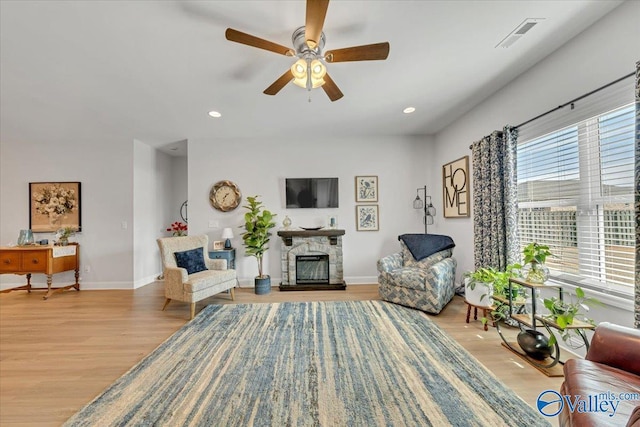 16604 Demi Dr, Athens, AL 35613 - living room featuring light wood finished floors, recessed lighting, and a stone fireplace