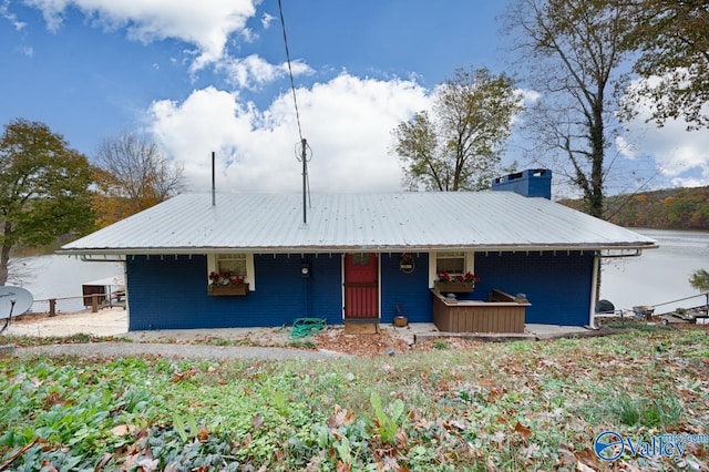 view of front of house with a water view