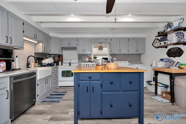 kitchen with wooden counters, light wood-type flooring, dishwasher, washing machine and dryer, and white electric range