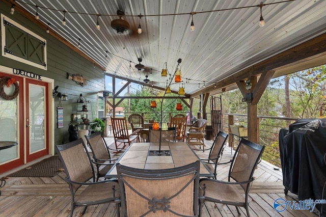 deck with grilling area and ceiling fan