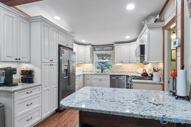 kitchen with white cabinetry, sink, dark hardwood / wood-style floors, and appliances with stainless steel finishes