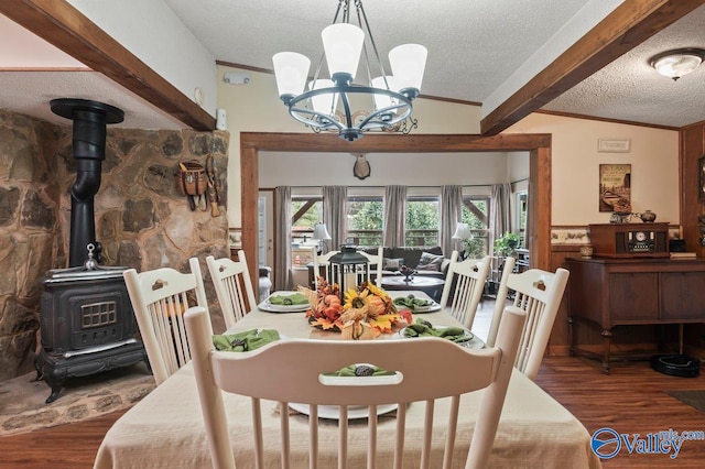 dining area with a wood stove, dark hardwood / wood-style flooring, lofted ceiling with beams, a chandelier, and a textured ceiling