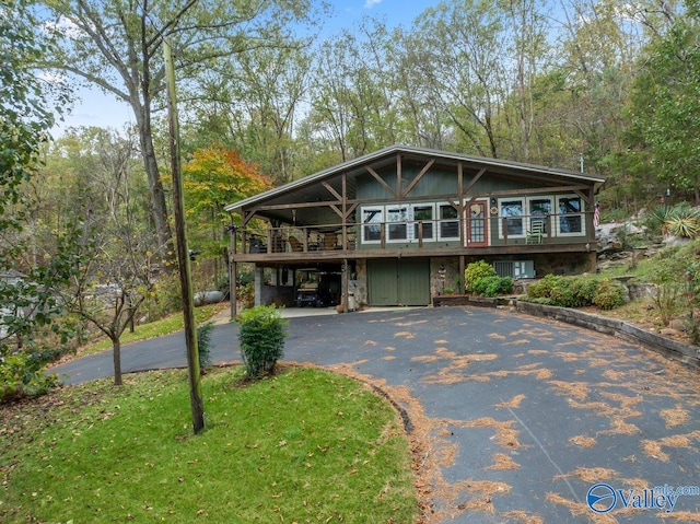 view of front of property with a carport and a wooden deck