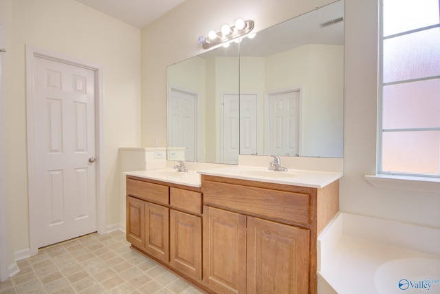 bathroom with vanity and a bath