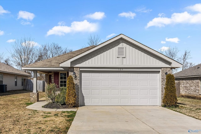 ranch-style home with a front yard, central AC unit, and a garage