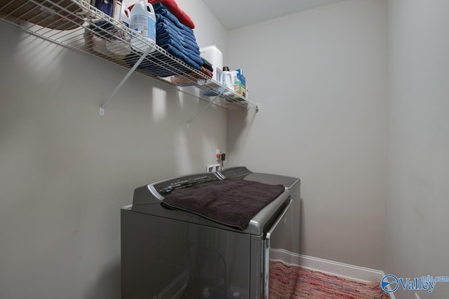 clothes washing area with washing machine and clothes dryer