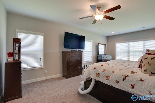 bedroom featuring light colored carpet and ceiling fan