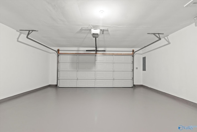 garage featuring a garage door opener, electric panel, and baseboards