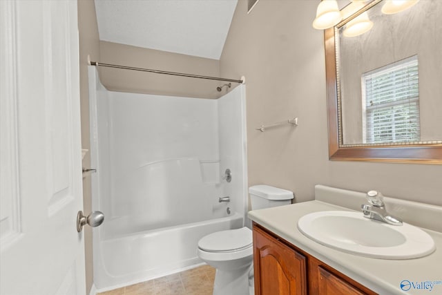 bathroom with a textured ceiling, shower / tub combination, tile patterned flooring, toilet, and vanity