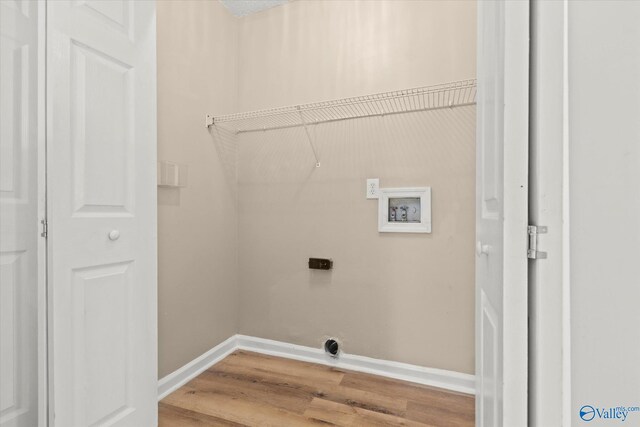 laundry room featuring hookup for a washing machine, hookup for an electric dryer, laundry area, wood finished floors, and baseboards