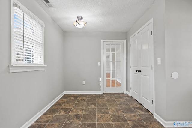 interior space with a textured ceiling