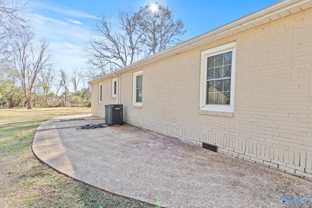 view of side of property featuring cooling unit and a patio area