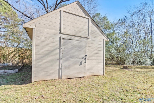 view of outbuilding featuring a yard