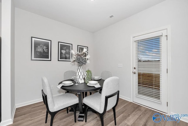 dining room with wood finished floors and baseboards