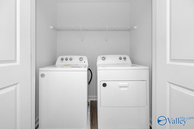 laundry area with washing machine and clothes dryer