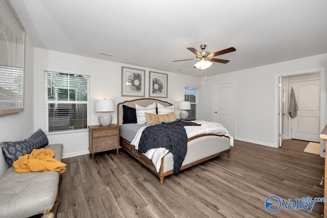 bedroom featuring wood finished floors, baseboards, and a ceiling fan