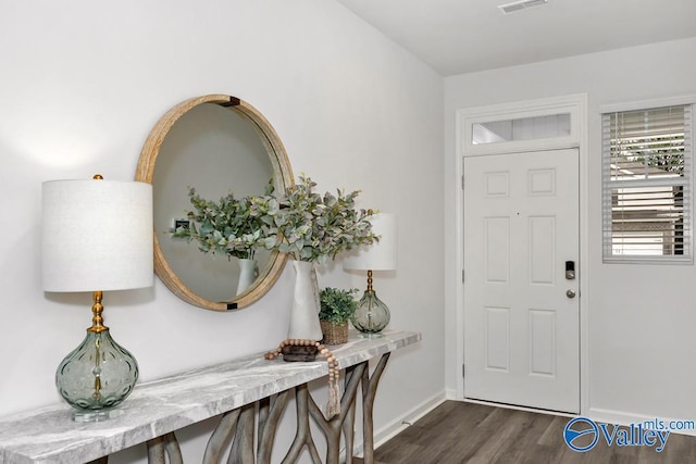entrance foyer featuring dark wood-style floors and baseboards