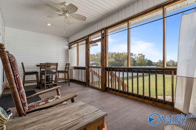 sunroom / solarium featuring ceiling fan