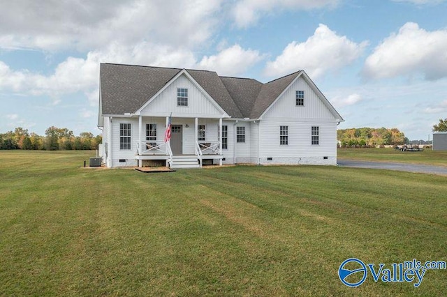 view of front of home featuring a front lawn, central AC unit, and a porch