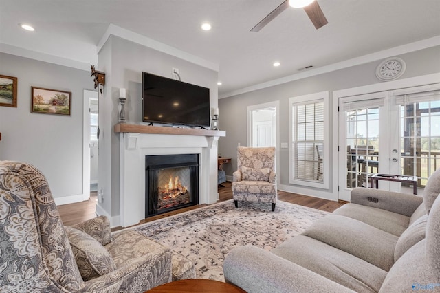 living room featuring hardwood / wood-style flooring, ceiling fan, french doors, and ornamental molding