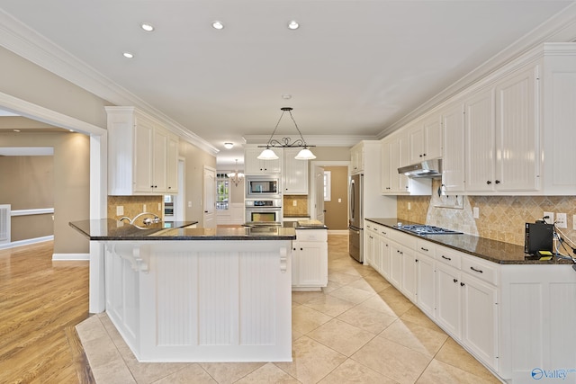 119 Railway Ln SE, Huntsville, AL 35803 - kitchen featuring appliances with stainless steel finishes, under cabinet range hood, white cabinetry, crown molding, and recessed lighting