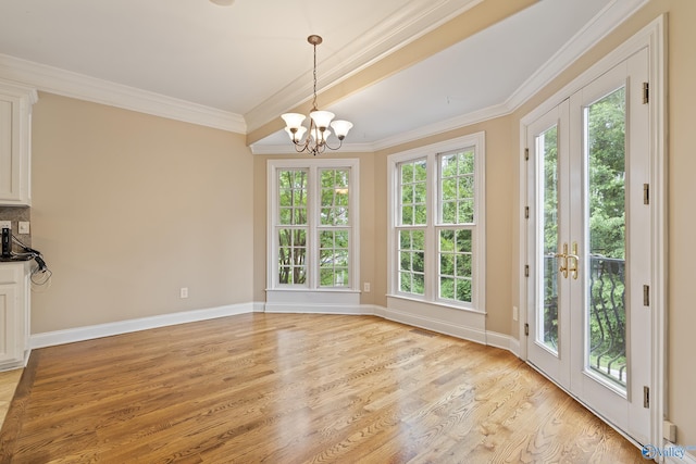 119 Railway Ln SE, Huntsville, AL 35803 - unfurnished dining area with a chandelier, light wood-style floors, ornamental molding, and baseboards