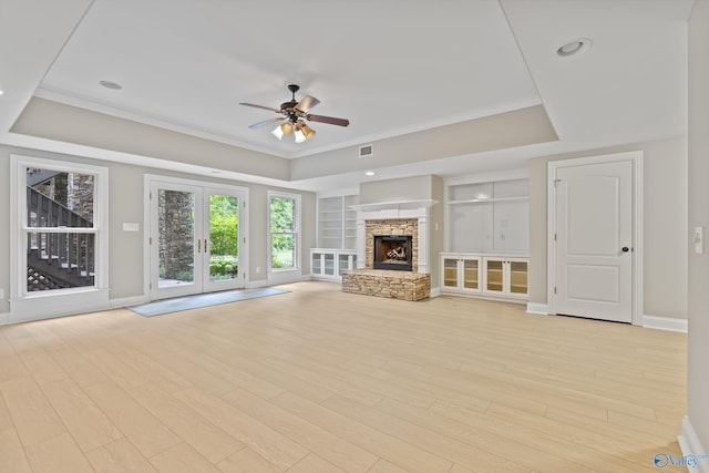 119 Railway Ln SE, Huntsville, AL 35803 - unfurnished living room featuring a tray ceiling, a ceiling fan, light wood finished floors, baseboards, and built in features