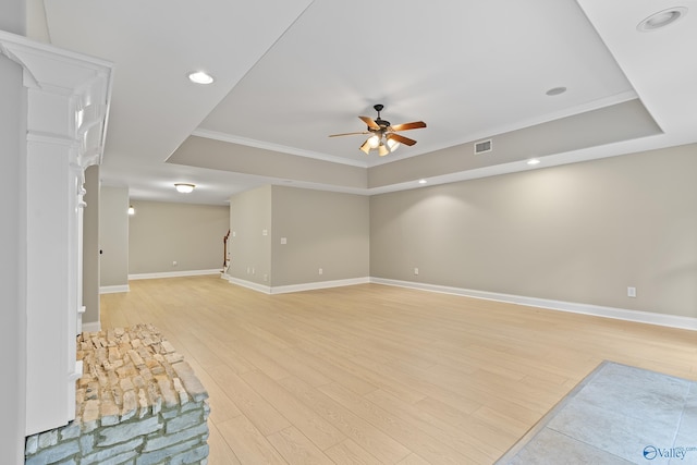 119 Railway Ln SE, Huntsville, AL 35803 - unfurnished living room featuring ceiling fan, a raised ceiling, light wood finished floors, baseboards, and crown molding