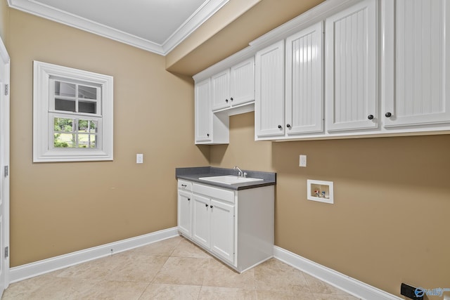 119 Railway Ln SE, Huntsville, AL 35803 - laundry area featuring crown molding, cabinet space, baseboards, washer hookup, and light tile patterned floors