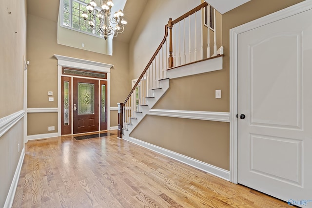 119 Railway Ln SE, Huntsville, AL 35803 - entryway with a chandelier, wood finished floors, a towering ceiling, stairs, and baseboards