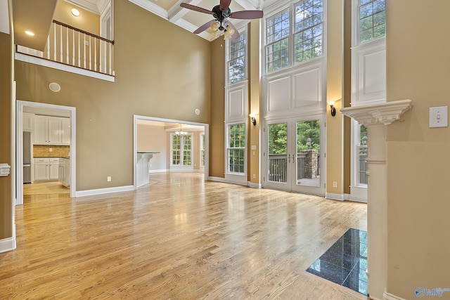 119 Railway Ln SE, Huntsville, AL 35803 - unfurnished living room featuring a high ceiling, ceiling fan, baseboards, light wood-type flooring, and beam ceiling