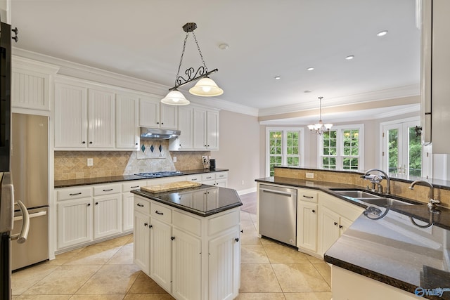 119 Railway Ln SE, Huntsville, AL 35803 - kitchen with appliances with stainless steel finishes, crown molding, tasteful backsplash, light tile patterned floors, and under cabinet range hood