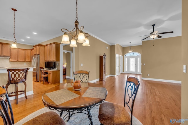 dining area featuring ceiling fan with notable chandelier, light hardwood / wood-style floors, and ornamental molding