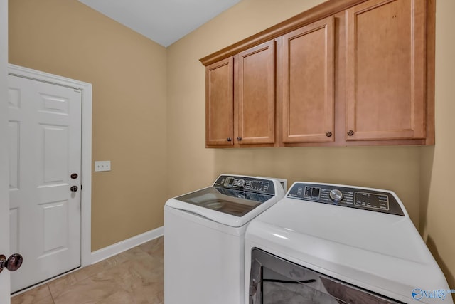 washroom featuring separate washer and dryer, cabinets, and light tile patterned flooring