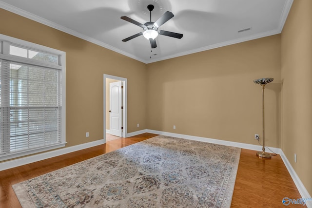 unfurnished room featuring ceiling fan, hardwood / wood-style flooring, and ornamental molding