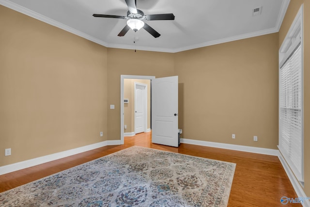 bedroom with ornamental molding, ceiling fan, and hardwood / wood-style flooring