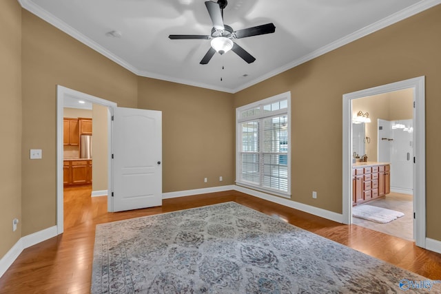 unfurnished bedroom featuring ornamental molding, light wood-type flooring, ensuite bath, and ceiling fan