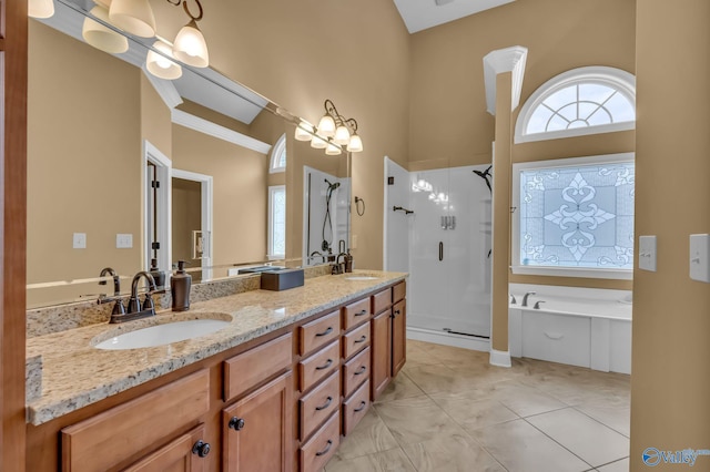 bathroom featuring independent shower and bath, vanity, a towering ceiling, and tile patterned floors