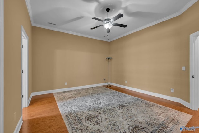 unfurnished room featuring ceiling fan, hardwood / wood-style floors, and crown molding