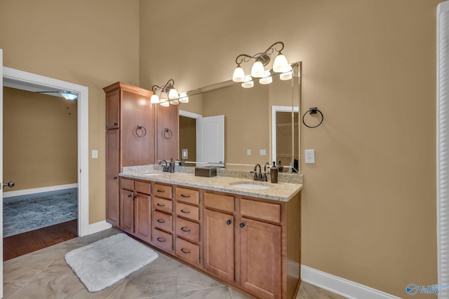 bathroom with ceiling fan, vanity, and hardwood / wood-style flooring