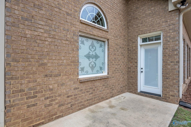 entrance to property featuring a patio