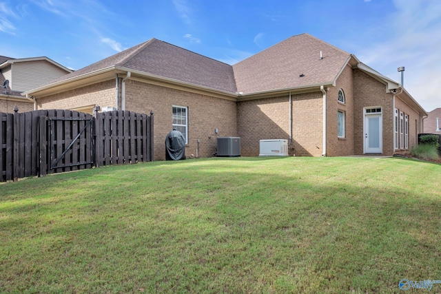 1006 Split Rock Cv, Huntsville, AL 35806 - back of house with brick siding, a gate, central air condition unit, and a yard