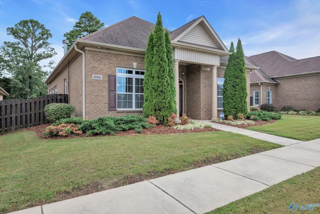 1006 Split Rock Cv, Huntsville, AL 35806 - view of front of property featuring brick siding, fence, a front yard, and roof with shingles