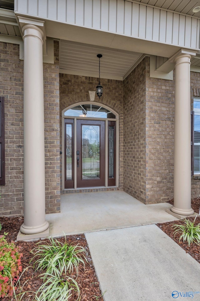 1006 Split Rock Cv, Huntsville, AL 35806 - property entrance featuring brick siding, board and batten siding, and covered porch